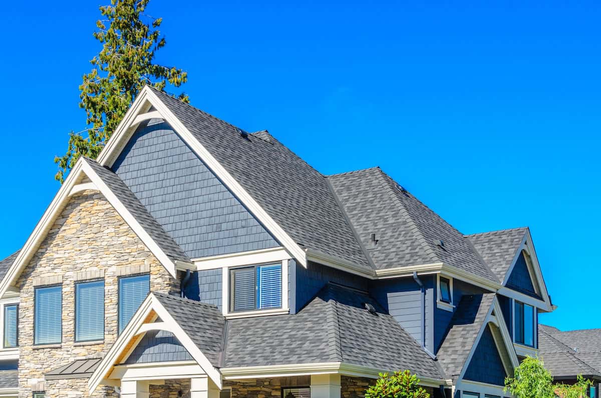 House with complex roof with asphalt shingles