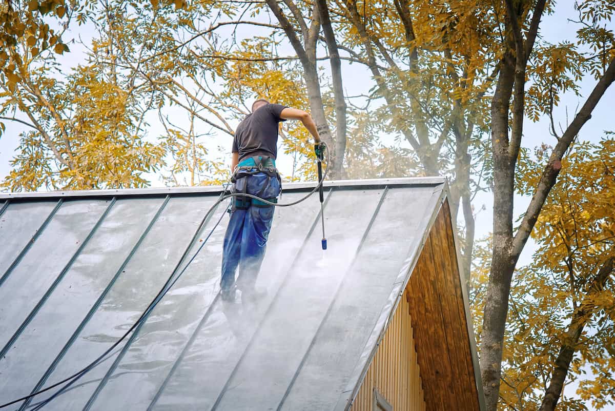 Pressure washing metal standing seam roof